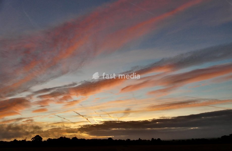 Pretty skies at daybreak as the sun rises over the countryside