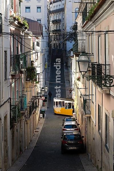 Old houses in narrow alleys and historic streets. Old house fronts in the morning and in the sunshine, Elevador da Bica in the old town of Bairro Alto, Lisbon, Portugal