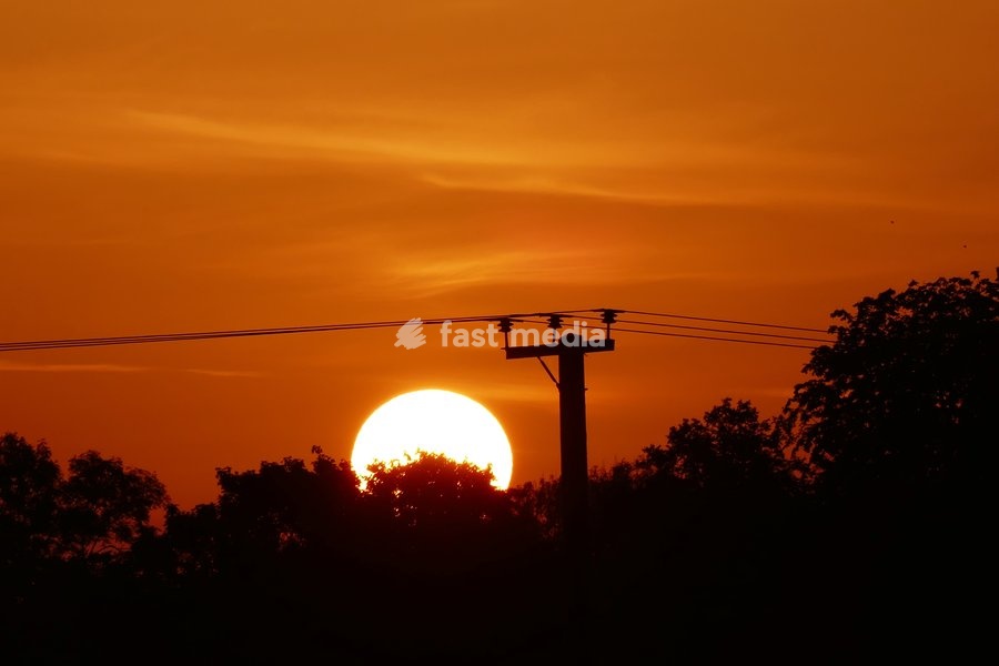 The days sun rises over the countryside on what is set be be another hot day of weather