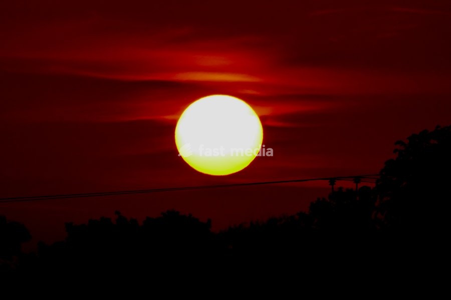 The days sun rises over the countryside on what is set be be another hot day of weather