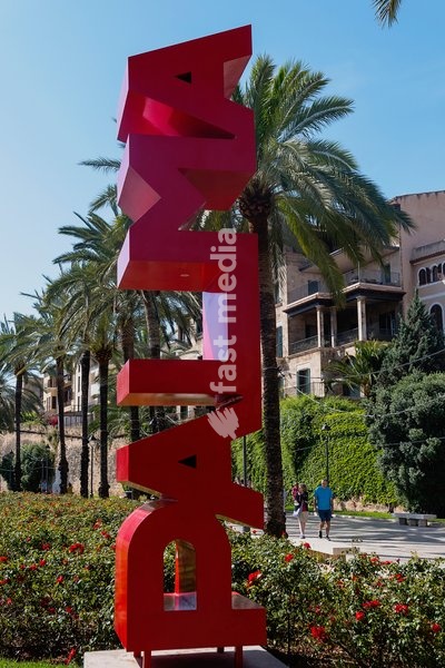 Spain, Balearic Islands, Majorca, Palma de Mallorca. Escultura Palma. Red Palma sign on the Paseo Sagrera or Passeig de Sagrera in Catalan, a quiet promenade on the seafront