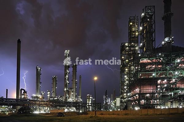 Lightning during thunderstorm above petrochemical industry in the Antwerp harbour at night, Belgium