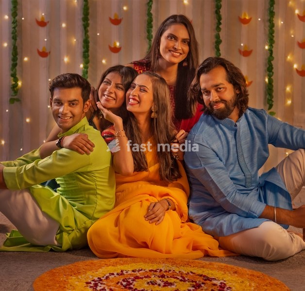 Friends in traditional outfit celebrating Diwali together at home