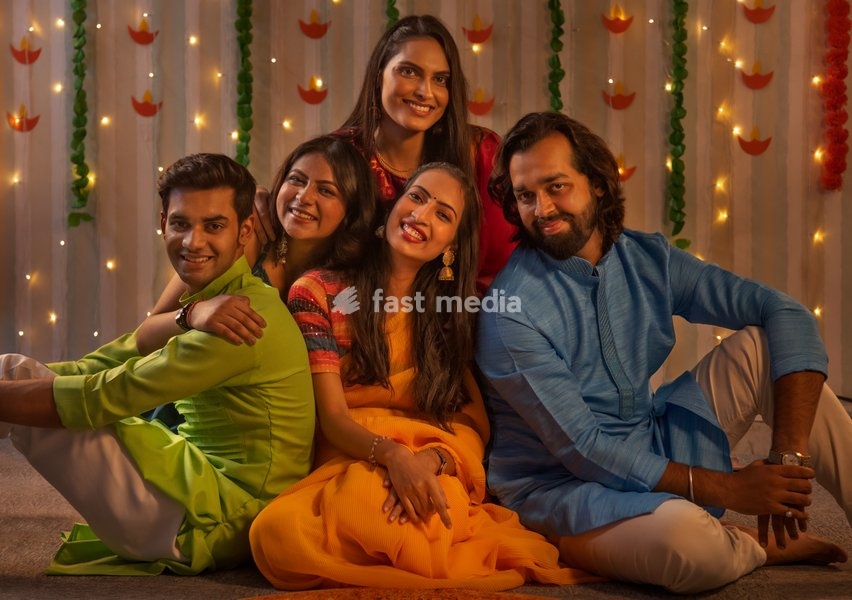 Friends in traditional outfit celebrating Diwali together at home