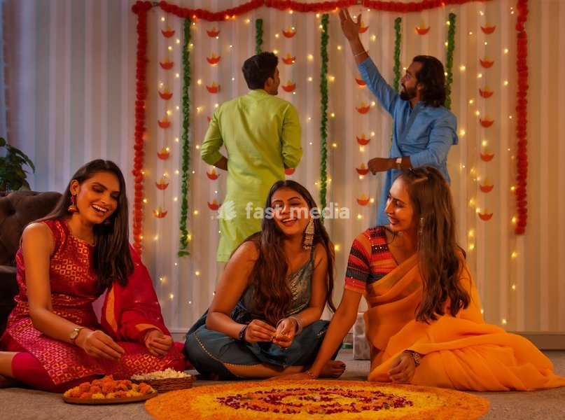 Friends decorating house on the occasion of Diwali