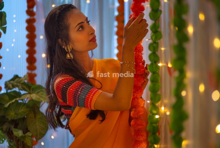 Young woman decorating house on the occasion of Diwali
