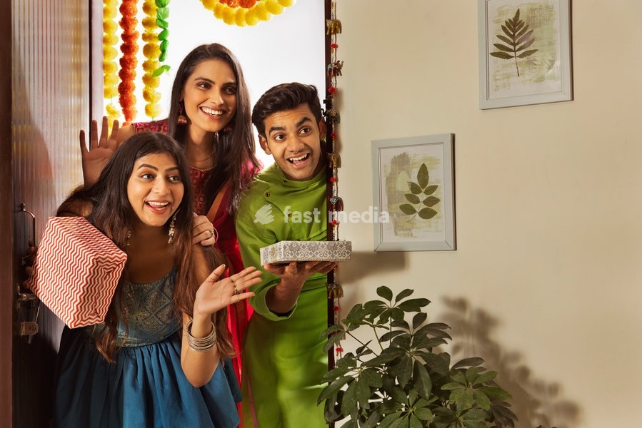 Group of friends arriving at house with gifts on the occasion of Diwali