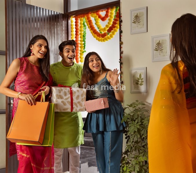 Group of friends arriving at house with gifts on the occasion of Diwali