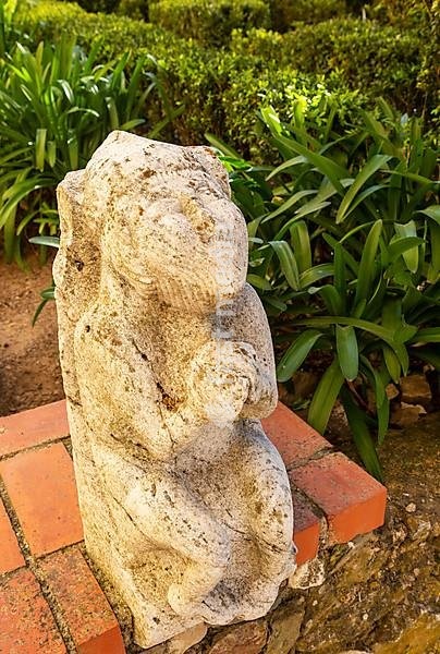 Historic stone carved stonework figure in castle garden of the Pousada Castelo de Altivo, Alvito, Baixo Alentejo, Portugal, southern Europe