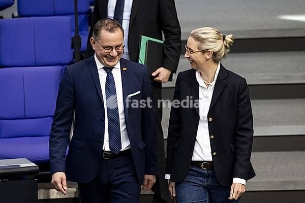 Tino Chrupalla, AfD, and Alice Weidel, AfD parliamentary group leader, arrive together in the plenary chamber of the German Bundestag in Berlin, 14 March 2024