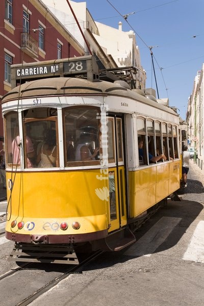 A number 28 tram runs along the scenic route popular with tourists in the Alfama district of Lisbon, Portugal, Europe