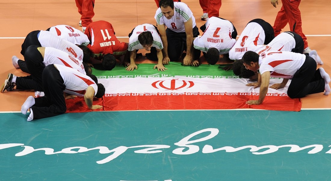 (101218) -- GUANGZHOU, Dec. 18, 2010 () -- Players of Iran kisses an Iranian national flag after winning the men's sitting volleyball final against China at the 2010 Asian Para Games in Guangzhou, capital city of south China's Guangdong Province, Dec. 18, 2010. Iran beat China 3-1 and claimed the…