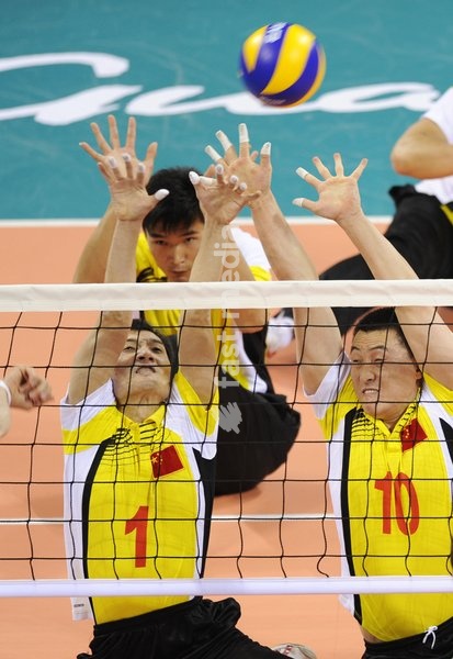 (101218) -- GUANGZHOU, Dec. 18, 2010 () -- China's Tong Jiao (L) and Zhao Peiwen block the net during the men's sitting volleyball final against Iran at the 2010 Asian Para Games in Guangzhou, capital city of south China's Guangdong Province, Dec. 18, 2010. China lost the match 1-3 and took the…