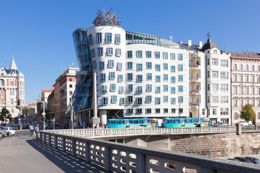 Tram in front of the Dancing House (Ginger and Fred) by Frank Gehry, Prague, Bohemia, Czech Republic, Europe