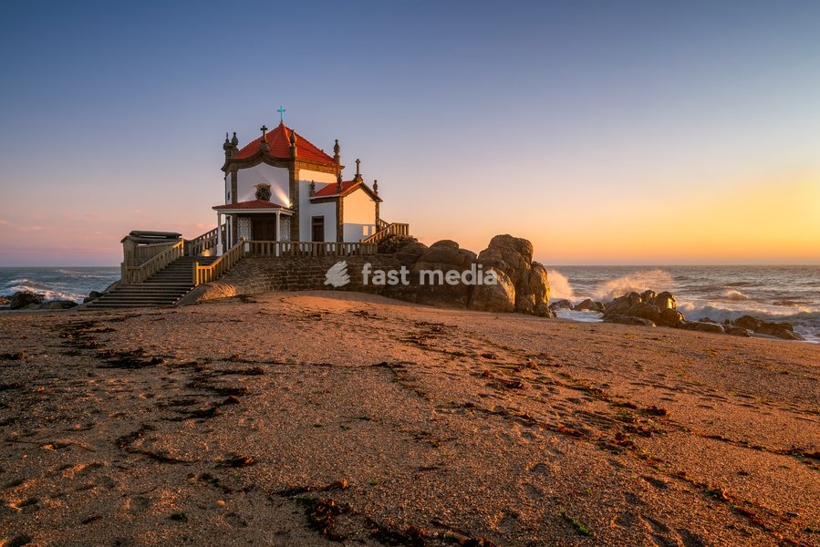 Beautiful chapel of Capela do Senhor da Pedra on the beach at sunset in Miramar, Vila Nova de Gaia, Portugal, Europe