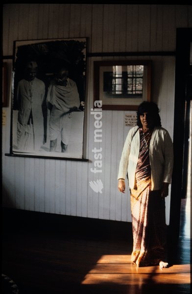 An Indian woman poses in front of artwork inside the Gandhi museum in Durban