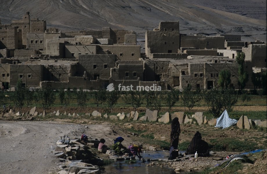 Women fetching water for washing clothes in their rural village