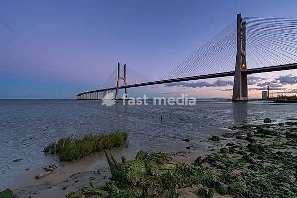 Ponte Vasco da Gama Bridge view near the Rio Tejo river after sunset