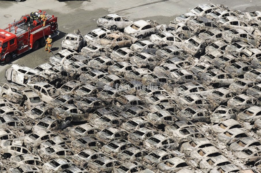 (110312) -- TOKYO, March 12, 2011 () -- Photo shows burnt vehicles that have been swept together at the port of Hitachi in Ibaraki Prefecture on March 12, 2011. Over 1,000 people has been killed after Friday's great earthquake and ensuing huge tsunami hit northeast Japan, public broadcaster NHK…