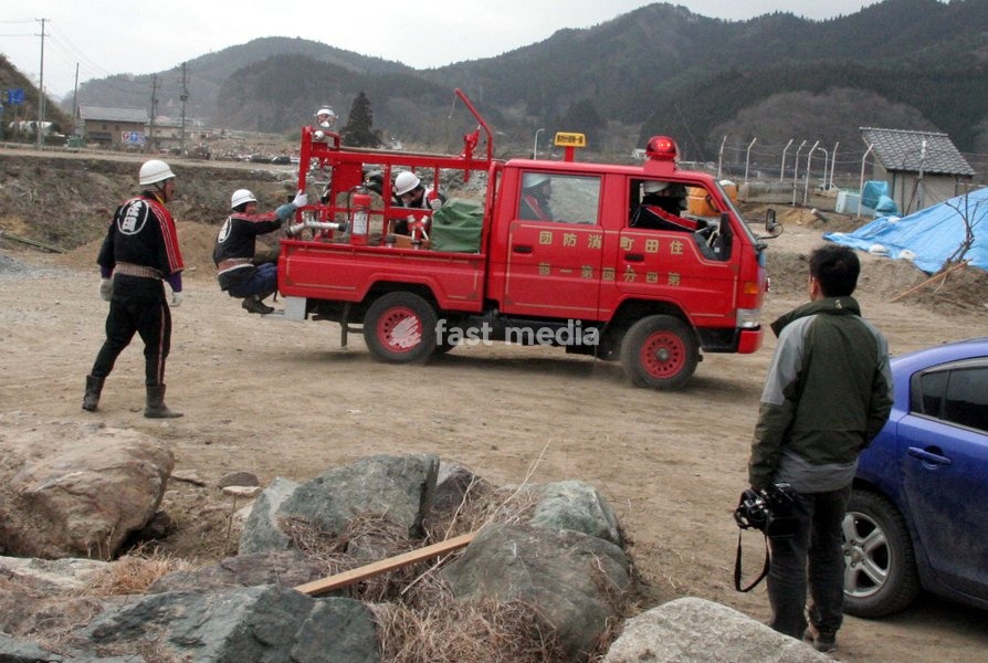 (110315) -- RIKUZEN-TAKATA, March 15, 2011 () -- Rescuers collect the bodies of victims in the city of Rikuzen-Takata, one of the cities worst hit by Friday's 9 Magnitude quake and ensuing tsunami, Iwate Prefecture, Japan, March 15, 2011