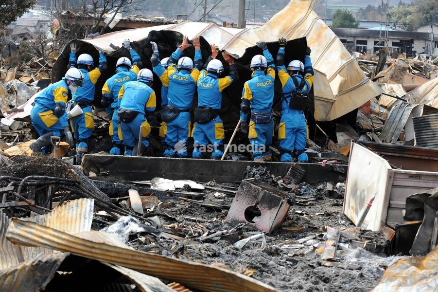 IWATE (JAPAN), March 22, 2011 () -- Rescue workers search for survivors in quake-devastated Iwate Prefecture, Japan, on March 22, 2011. The National Police Agency said Tuesday that the catastrophic earthquake and ensuing tsunami have left 9,079 dead and 12,645 others unaccounted for in Japan by…