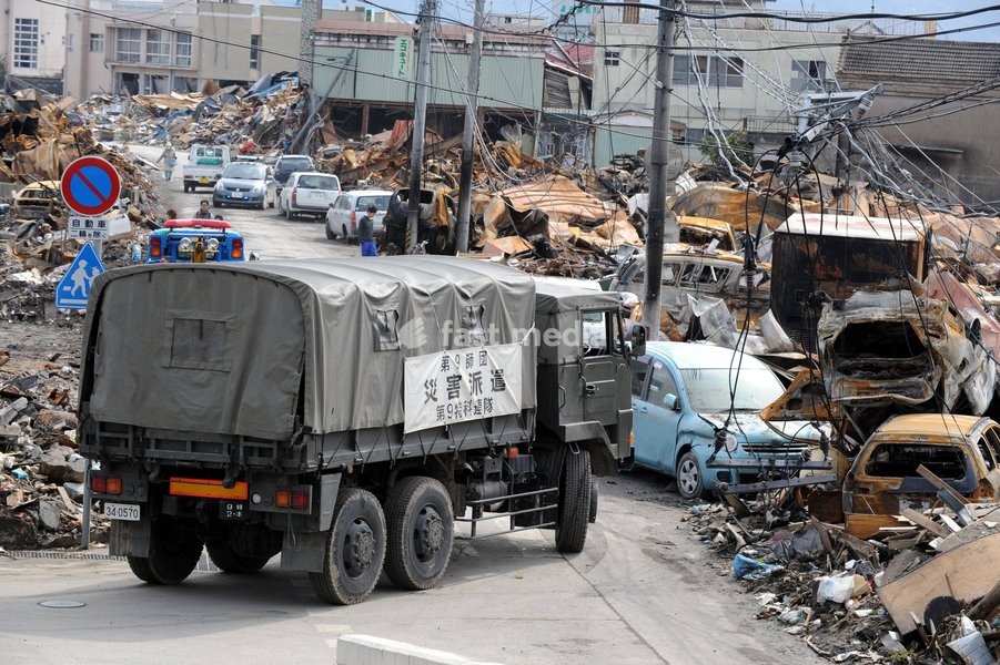 IWATE (JAPAN), March 22, 2011 () -- A rescue ambulance drives among the debris in quake-devastated Iwate Prefecture, Japan, on March 22, 2011. The National Police Agency said Tuesday that the catastrophic earthquake and ensuing tsunami have left 9,079 dead and 12,645 others unaccounted for in Japan…