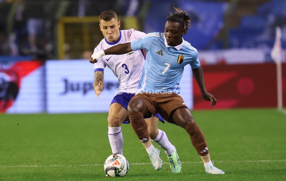 Belgium's Jeremy Doku and France's Lucas Digne fight for the ball during a soccer game between Belgian national soccer team Red Devils and France, match 4 (out of 6) in the League A Group 2 of the UEFA Nations League 2025 competition, Monday 14 October 2024 in Brussels