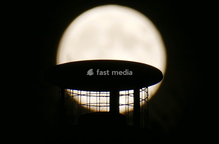 The Hunters Moon, super moon visible over the woods in the evenings sky. Super moons happen when the Moon is closest to the Earth, appearing much bigger and brighter than normal. October's full Moon is called the Hunter's Moon because it occurs when hunters would traditionally have been most active