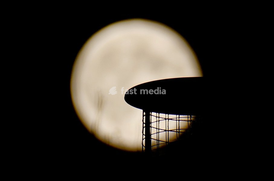 The Hunters Moon, super moon visible over the woods in the evenings sky. Super moons happen when the Moon is closest to the Earth, appearing much bigger and brighter than normal. October's full Moon is called the Hunter's Moon because it occurs when hunters would traditionally have been most active