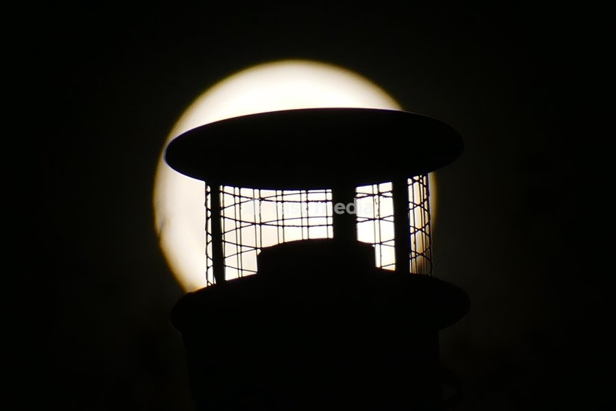 The Hunters Moon, super moon visible over the woods in the evenings sky. Super moons happen when the Moon is closest to the Earth, appearing much bigger and brighter than normal. October's full Moon is called the Hunter's Moon because it occurs when hunters would traditionally have been most active