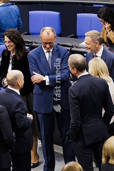 Olaf Scholz (SPD), Federal Chancellor, greets Friedrich Merz, CDU, and Christian Lindner in plenary in front of the session in the German Bundestag, Berlin, 13 November 2024