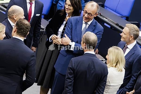 Olaf Scholz (SPD), Federal Chancellor, greets Friedrich Merz, CDU, and Christian Lindner in plenary in front of the session in the German Bundestag, Berlin, 13 November 2024