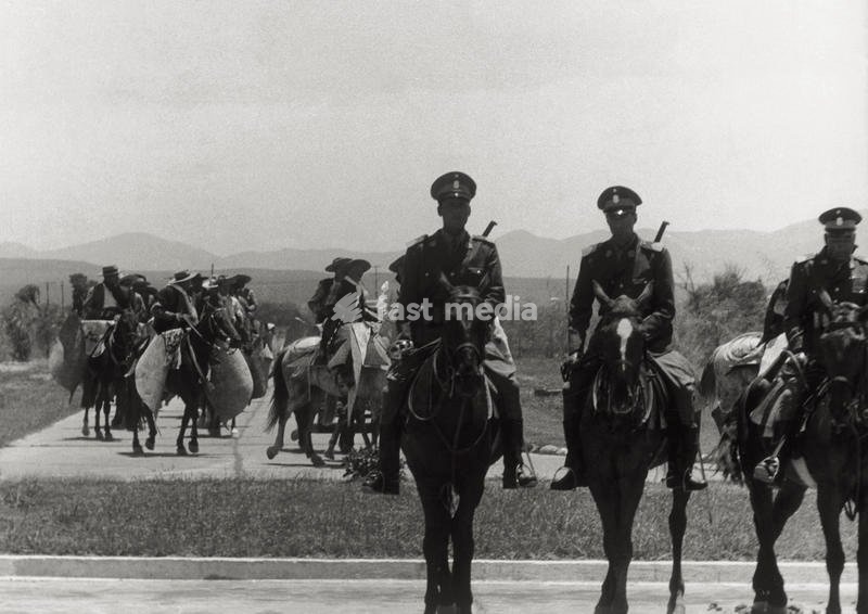 Argentine mounted police deployed in front of a group of gauchos riding in a row. Argentina, November 1957 SPECIAL FEE - CONTACT US FOR NOT EDITORIAL USAGE