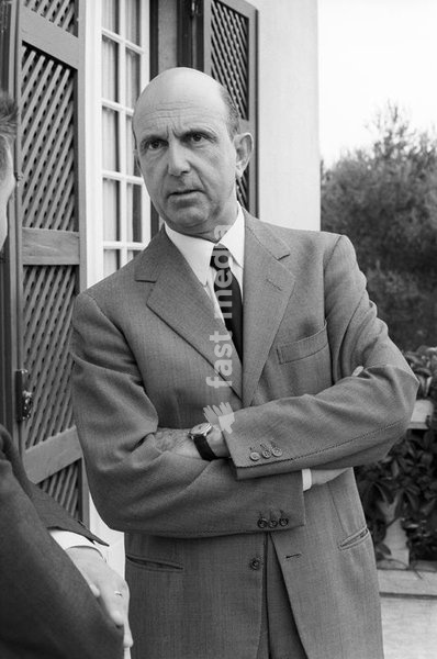The last King of Italy Umberto II (Umberto Nicola Tommaso Giovanni Maria di Savoia) standing still with his arms folded on the balcony of the villa where he spends his exile. Cascais, 1960s