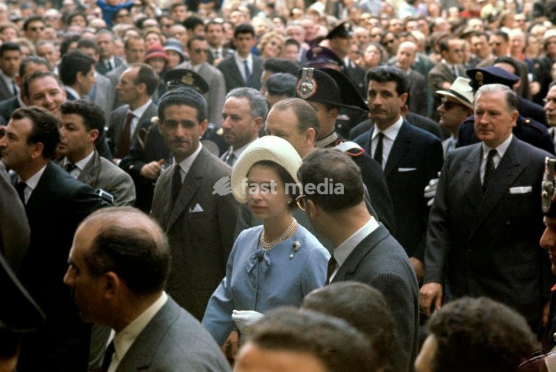 Elizabeth II, wearing a light-blue tailleur, visits Piazza San Marco, among a big crowd; the Queen is travelling through Italy together with Prince Philip in the occasion of the centenary of the national Unification. Venice (Italy), May 1961. SPECIAL FEE - CONTACT US FOR NOT EDITORIAL USAGE