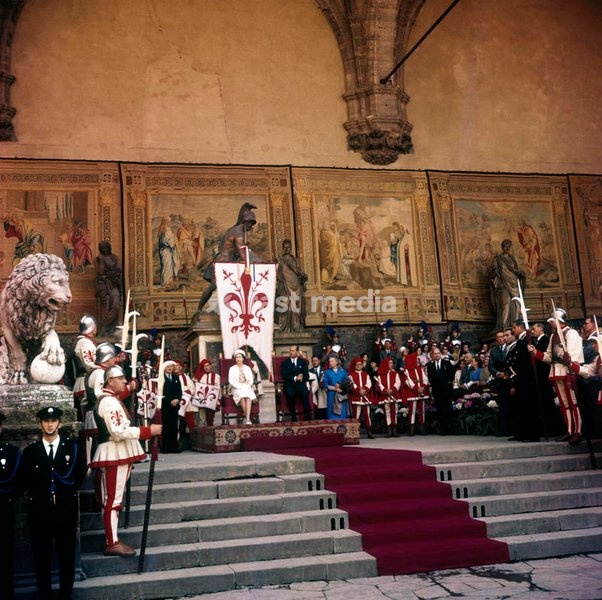 The Loggia dei Lanzi, in Piazza della Signoria, is set up with the Gonfalon and the series of tapestries with the Stories of St. John (from Del Sarto frescoes), to give the most distinguished welcome to the Queen Elizabeth and her husband, the Prince Philip, in Italy for the celebrations of the…