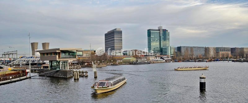 Canals in the old town center, with boats and floating houses on both sides. Amsterdam, 7th December 2016