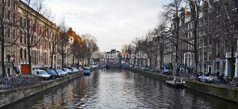Canals in the old town center, with boats and floating houses on both sides. Amsterdam, 7th December 2016