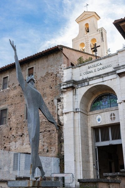 Facade of the Basilica of Santi Cosma e Damiano with a statue of San Francesco d'Assisi made by Father Andrea Martini. Rome (Italy), December 30th, 2021 SPECIAL FEE - CONTACT US FOR NOT EDITORIAL USAGE