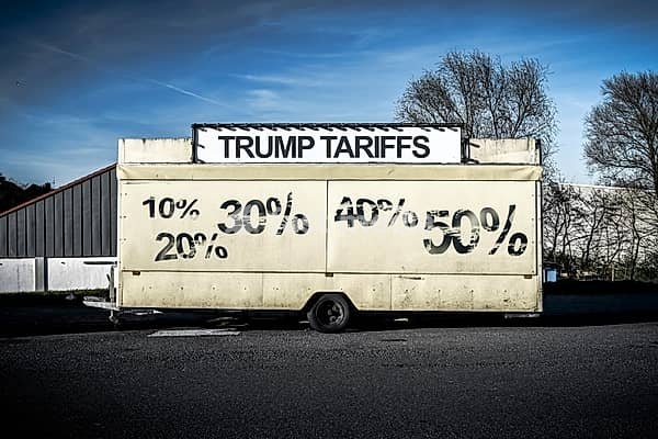 Trailer with inscription Trump tariffs and percentage figures, symbolic photo tariff dispute and punitive tariffs, photomontage