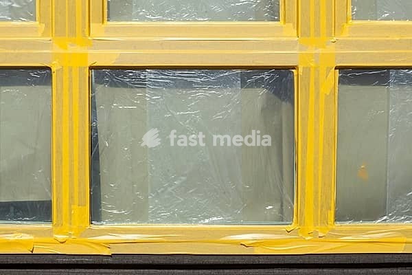 Window taped up with adhesive tape during a renovation, Germany, Europe